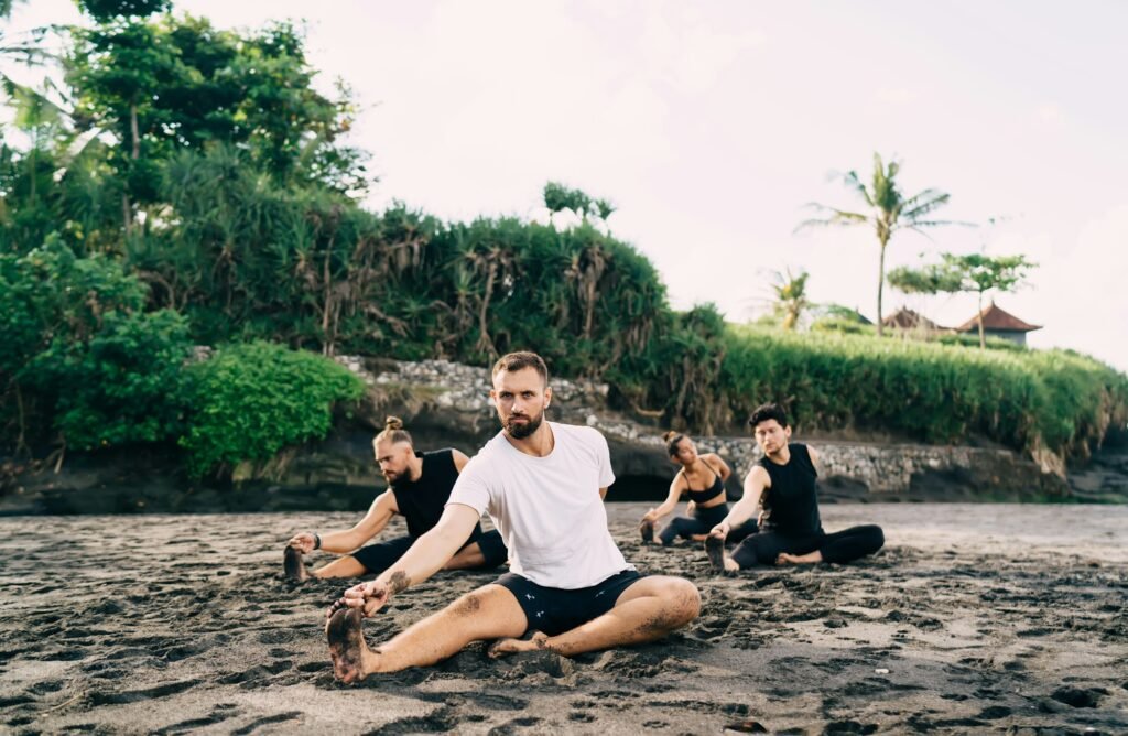 Group of mindfulned male and female concentrated on holistic retreat